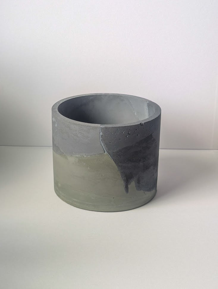 Concrete planter with gray and green marbled pattern on a white background