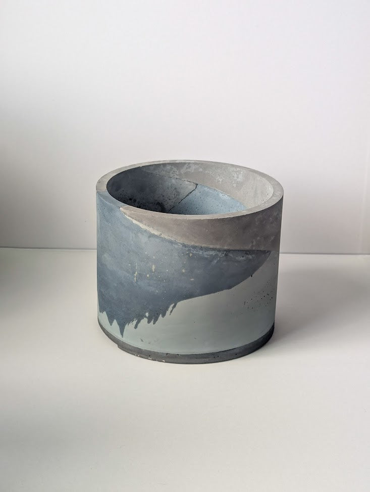 Concrete pot with gradient design on a white background