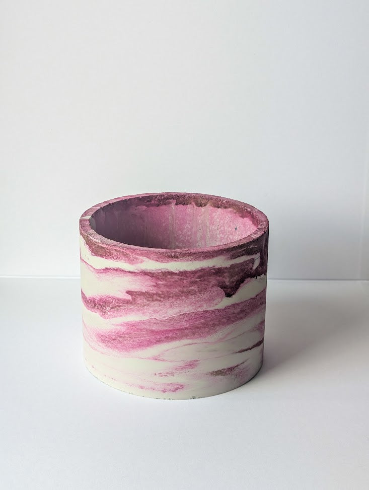 Marbled pink and white concrete planter on a white background